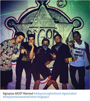A group of students poses at a themed party using the hashtag #Sigtopia. Instagram photo from "over 1 year ago."